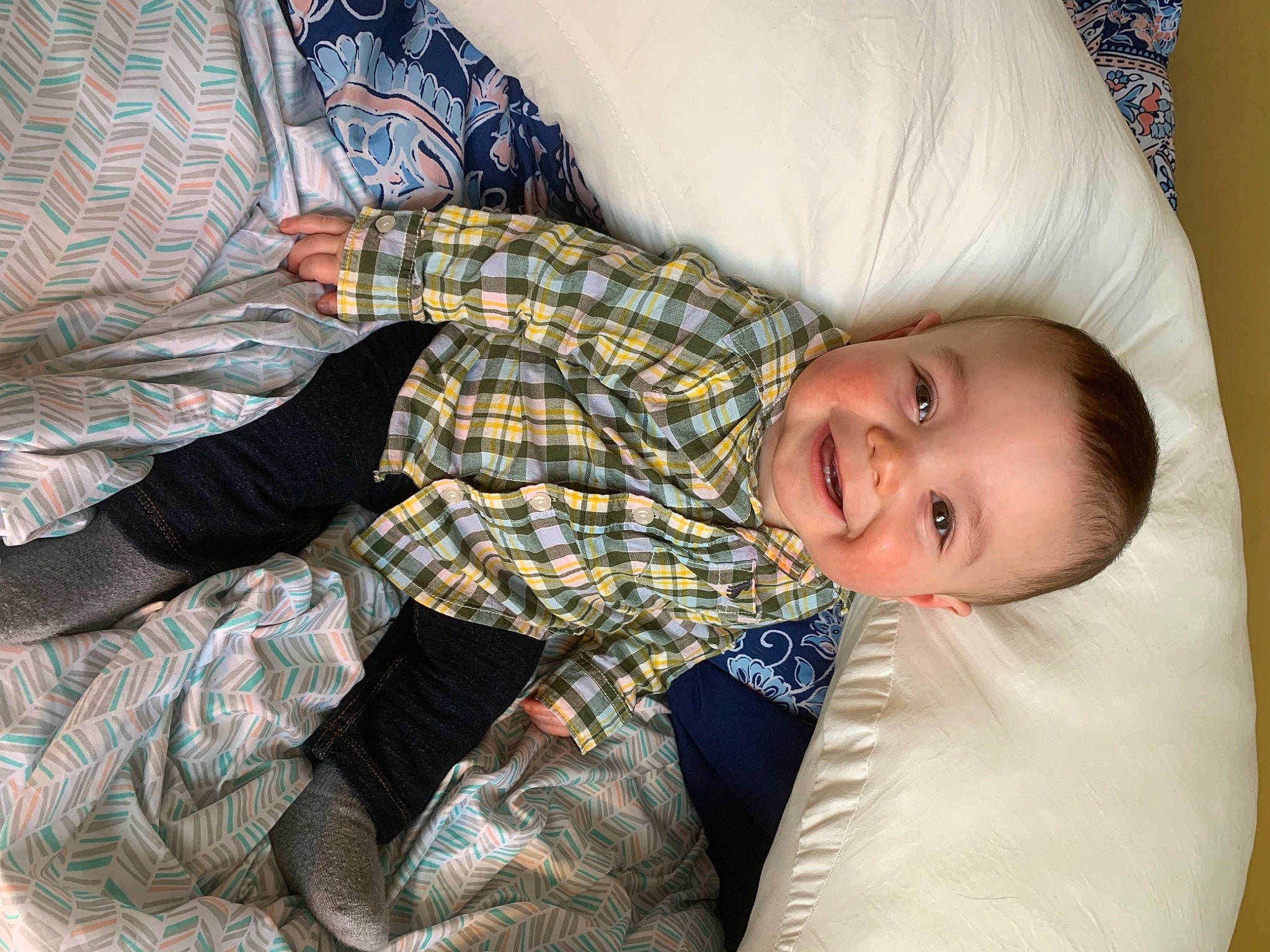 Bentlee is registered to the contest to win money with this photo: baby, baby_toddler_clothing, child, comfort, couch, elbow, happy, human_leg, joy, lap, linens, mammal, pattern, person, plaid, room, sitting, sleeve, smile, tartan