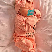 Amara is registered to the contest to win money with this photo: newborn, baby, infant, pacifier, bow, headband, sleeping, pink, peach, clothing, blanket, soft_texture, cute, tiny_toes, portrait, cozy, indoors, resting, child, peaceful