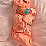 newborn, baby, infant, pacifier, bow, headband, sleeping, pink, peach, clothing, blanket, soft_texture, cute, tiny_toes, portrait, cozy, indoors, resting, child, peaceful