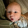 Oliver is registered to the contest to win money with this photo: baby, child, clothing, couch, cute, expression, eyes, face, hand, head, indoor, infant, mouth, newborn, onesie, person, pillow, portrait, skin, surprised