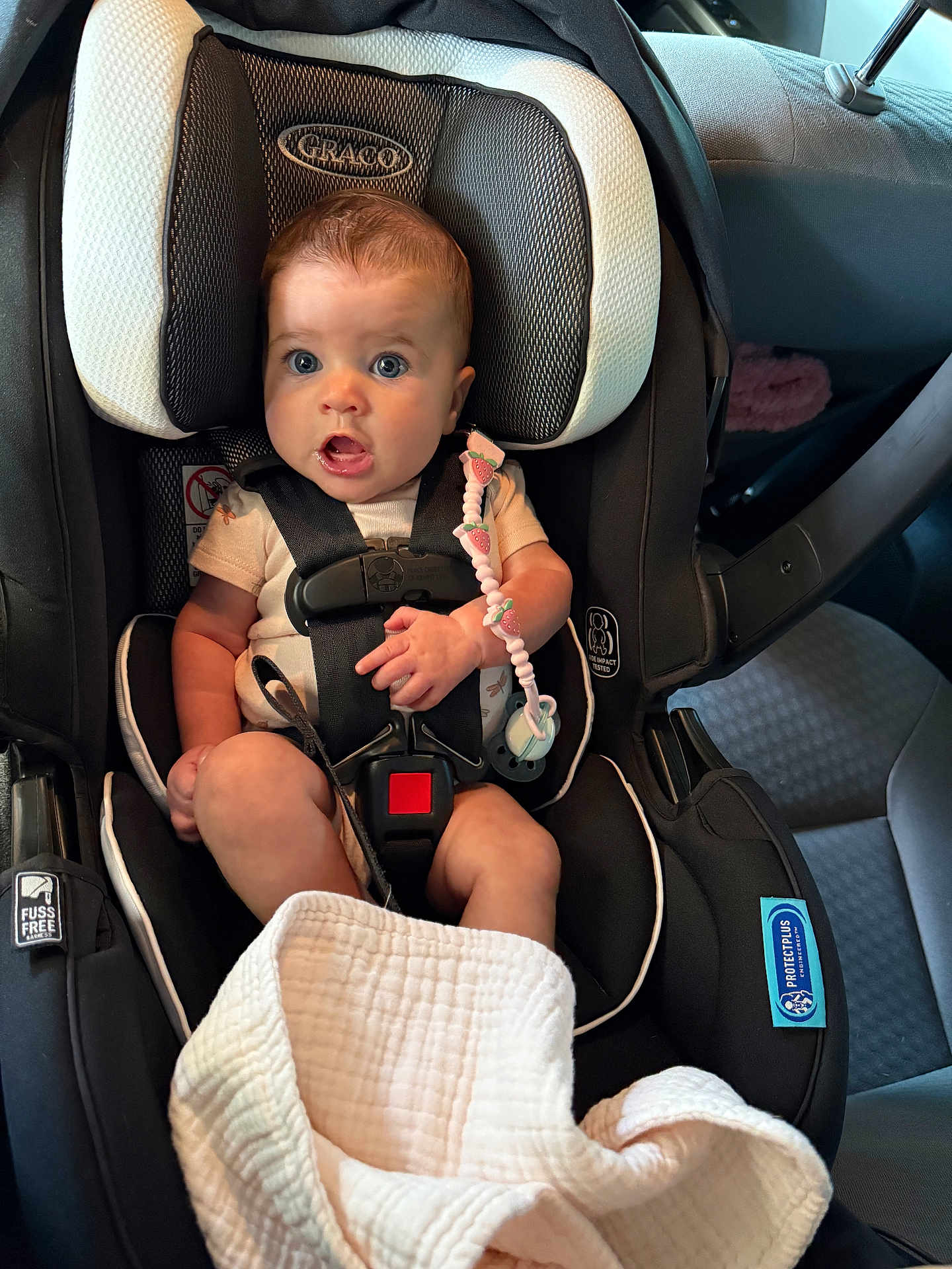 Oakley is registered to the contest to win money with this photo: baby, car_seat, infant, child, seatbelt, pacifier, blanket, graco, car_interior, safety, cute, young_child, sitting, clothing, comfort, transportation, strap, head_support, expression, indoors