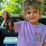 Bailey is registered to the contest to win money with this photo: child, girl, curly_hair, purple_shirt, crawfish, outdoor, nature, cooler, truck_bed, greenery, smile, summer, daylight, face, hand, animal, recreation, happy, portrait, holding
