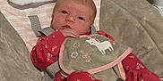Riley-Hope is registered to the contest to win money with this photo: baby, baby_girl, baby_seat, bib, carpet, child, comfort, cute, face, head_support, indoors, infant, newborn, person, plush, red_clothing, resting, sleepwear, unicorn, young