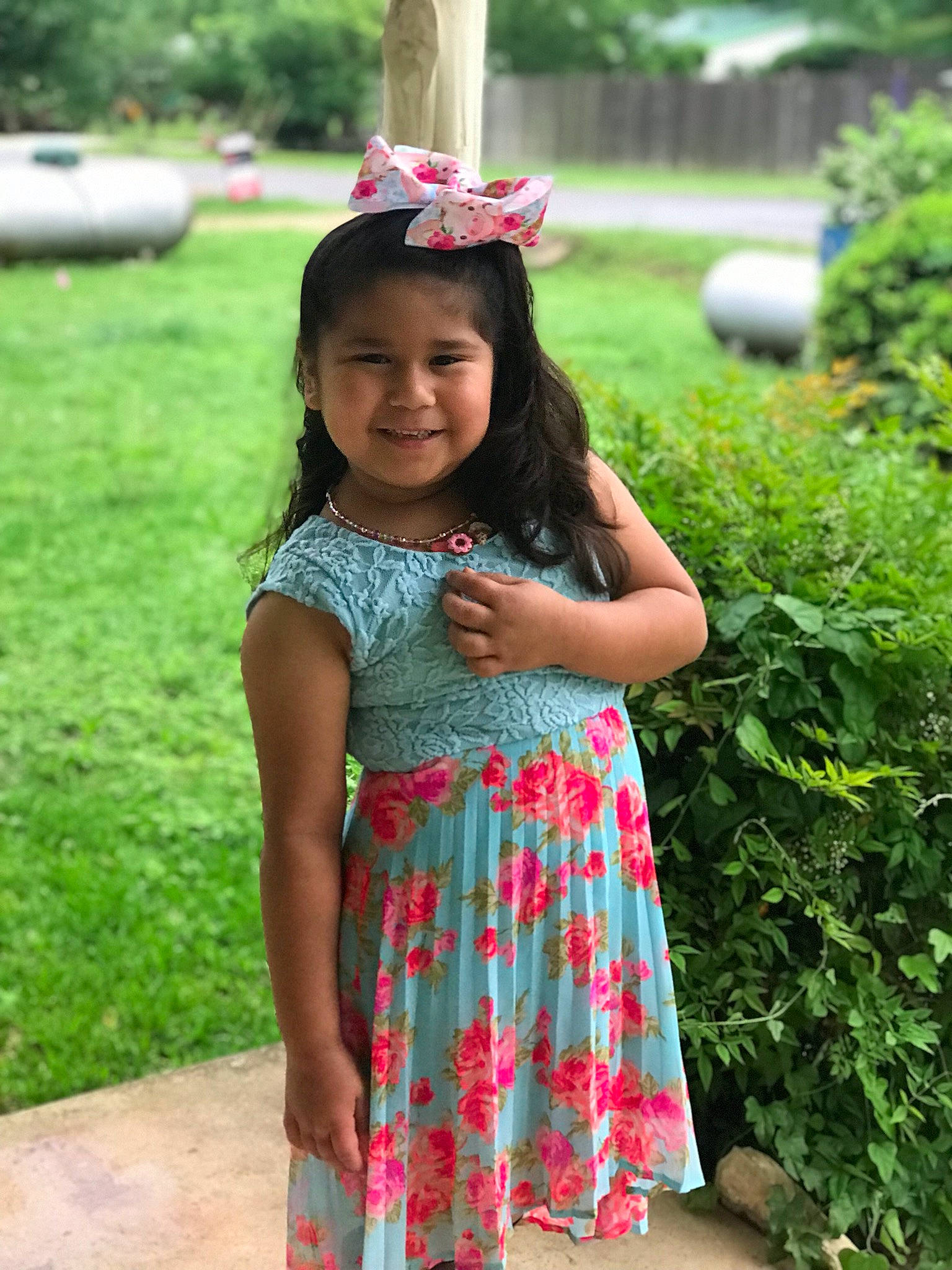 Khloe is registered to the contest to win money with this photo: baby_toddler_clothing, clothing, costume_accessory, day_dress, dress, embellishment, garden, hair_accessory, headband, headpiece, hedge, joy, one_piece_garment, pattern, person, pink, shrub, spring, summer, toddler