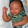 Jahlani is registered to the contest to win money with this photo: baby, bassinet, blanket, camouflage, child, cozy, cute, eyelids, face, hand, indoors, infant, newborn, onesie, peaceful, person, resting, sleeping, soft, toddler