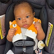 Jahlani joined the competition — help win amazing prizes! adorable, baby, car_seat, child, closeup, clothing, curious, cute, fox_plush, indoors, infant, pacifier, person, safety, seatbelt, secure, sitting, soft_toys, straps, young_child