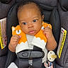 adorable, baby, car_seat, child, closeup, clothing, curious, cute, fox_plush, indoors, infant, pacifier, person, safety, seatbelt, secure, sitting, soft_toys, straps, young_child