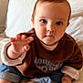Joyce participe au concours pour gagner de l'argent avec cette photo : baby, child, infant, cute, hand, bed, pillow, orange_headboard, sweatshirt, jeans, indoor, portrait, looking_at_camera, curious, soft_lighting, skin, person, candid, cozy, home