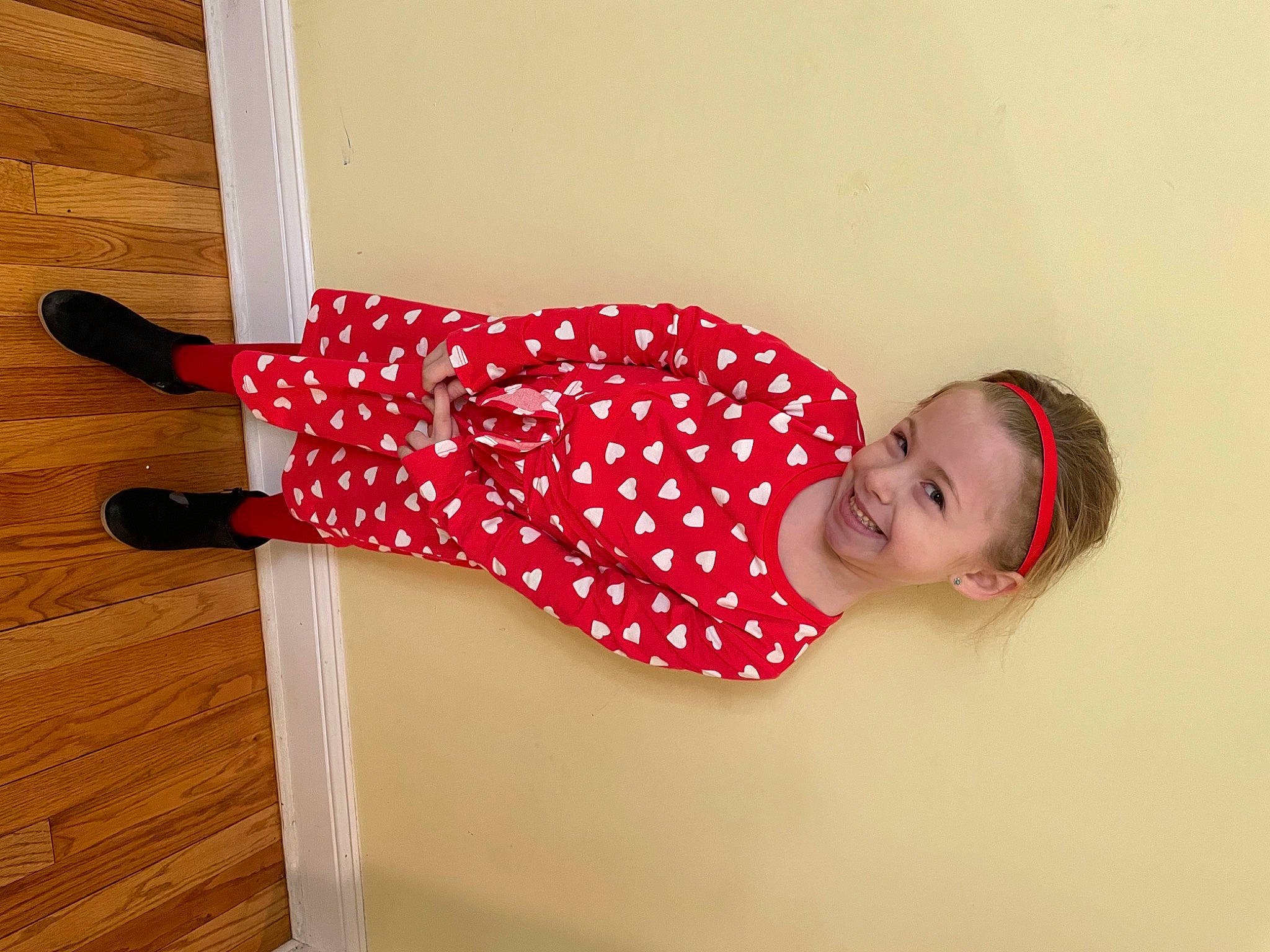 Harper is registered to the contest to win money with this photo: baby_toddler_clothing, carmine, child, comfort, dress, elbow, floor, flooring, happy, hardwood, human_leg, joy, knee, magenta, pattern, person, sleeve, smile, thigh, toddler