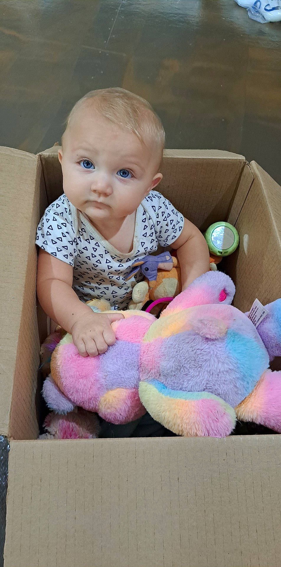 Khaleesi is registered to the contest to win money with this photo: baby, baby_playing_with_toys, baby_products, baby_toddler_clothing, cheek, child, comfort, iris, linens, magenta, pattern, person, pink, purple, room, sitting, sock, stuffed_toy, toddler, toy