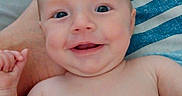 Fiona joined the competition — help win amazing prizes! baby, smile, face, skin, bare_chest, hand, foot, blanket, striped, blue, white, nail_polish, happy, child, infant, portrait, cute, lying_down, person, relaxed
