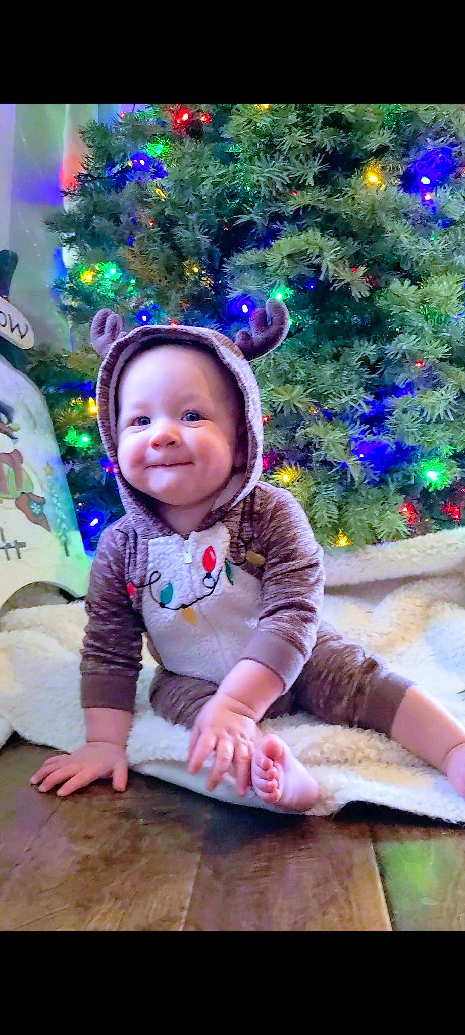 Lincoln is registered to the contest to win money with this photo: baby, baby_toddler_clothing, child, christmas, christmas_decoration, christmas_ornament, christmas_tree, event, face, fun, grass, happy, holiday, human_body, joy, person, pink, purple, smile, toddler