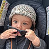 baby, child, car_seat, knitted_hat, sunglasses, hands, blue_eyes, cute, infant, seat_belt, clothing, portrait, indoor, person, young_child, closeup, curious, playing, seat, safety