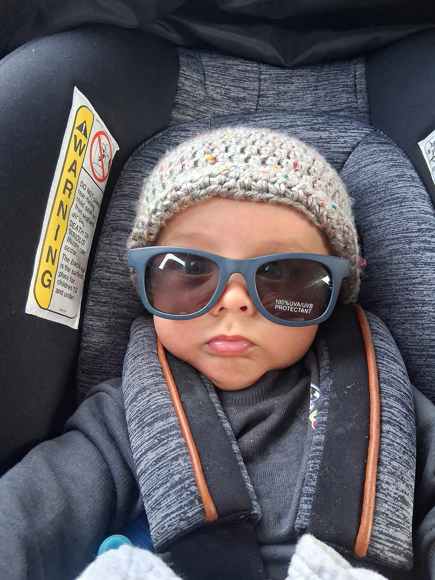 Angelemmanuel is registered to the contest to win money with this photo: baby, sunglasses, hat, car_seat, child, pout, knitted_hat, pacifier, clothing, seatbelt, infant, portrait, cute, child_seat, face, person, warm_clothing, accessory, indoor, serious