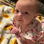 Adalynn joined the competition — help win amazing prizes! baby, infant, blanket, sunflower, floral_clothing, cute, portrait, face, skin, eyes, hand, indoor, soft, comfort, child, young, expression, lying_down, closeup, adorable