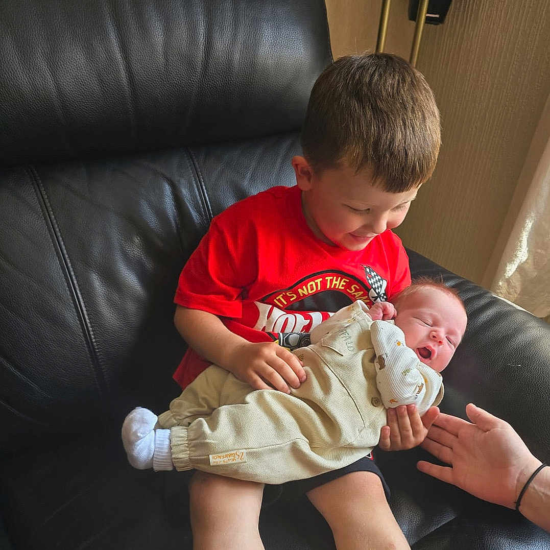 Noah Thomas Lewis is registered to the contest to win money with this photo: baby, boy, chair, child, clothing, couch, cushion, face, furniture, head, homedecor, male, newborn, person, photography, portrait, shorts, sitting, sleeping, t_shirt