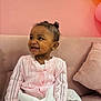 toddler, child, smile, pink_cardiagn, white_dress, curly_hair, earrings, couch, pillow, indoor, happy, cute, fashion, portrait, sitting, baby, cozy, soft_lighting, background, home