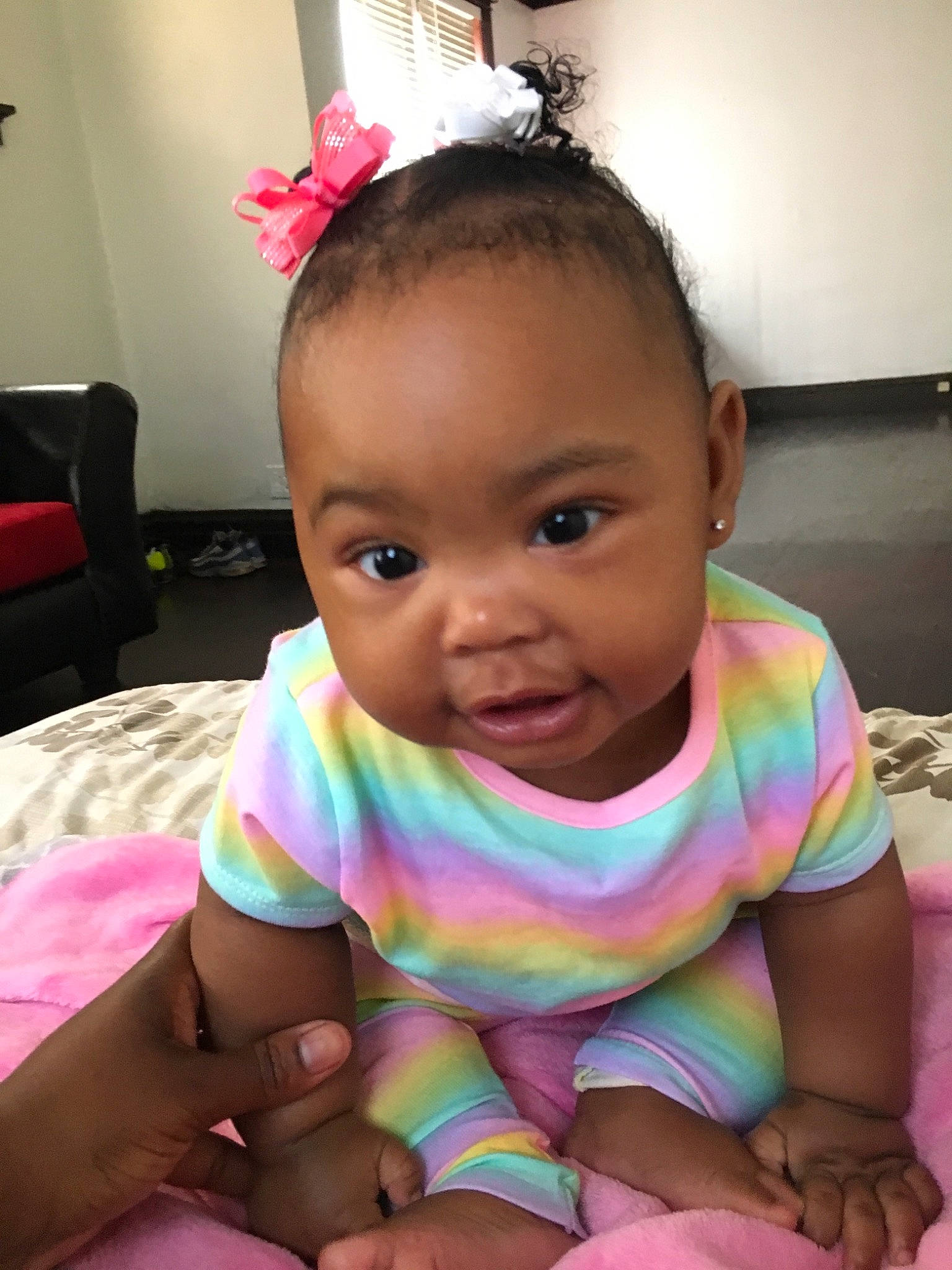 Nia is registered to the contest to win money with this photo: baby, baby_toddler_clothing, beauty, cheek, child, ear, face, finger, forehead, hair_accessory, happy, head, lip, mouth, neck, person, pink, sitting, skin, smile