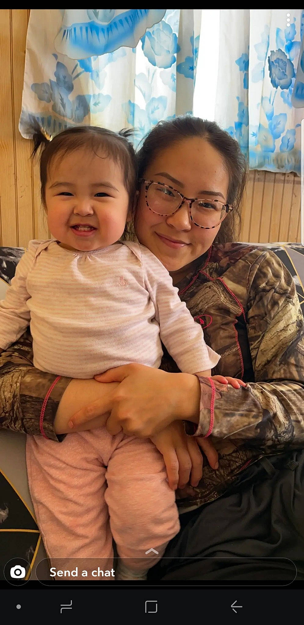 Helena is registered to the contest to win money with this photo: baby_toddler_clothing, cheek, comfort, face, finger, friendship, gesture, glasses, happy, head, interaction, iris, joy, mammal, military_camouflage, person, skin, sleeve, smile, t_shirt