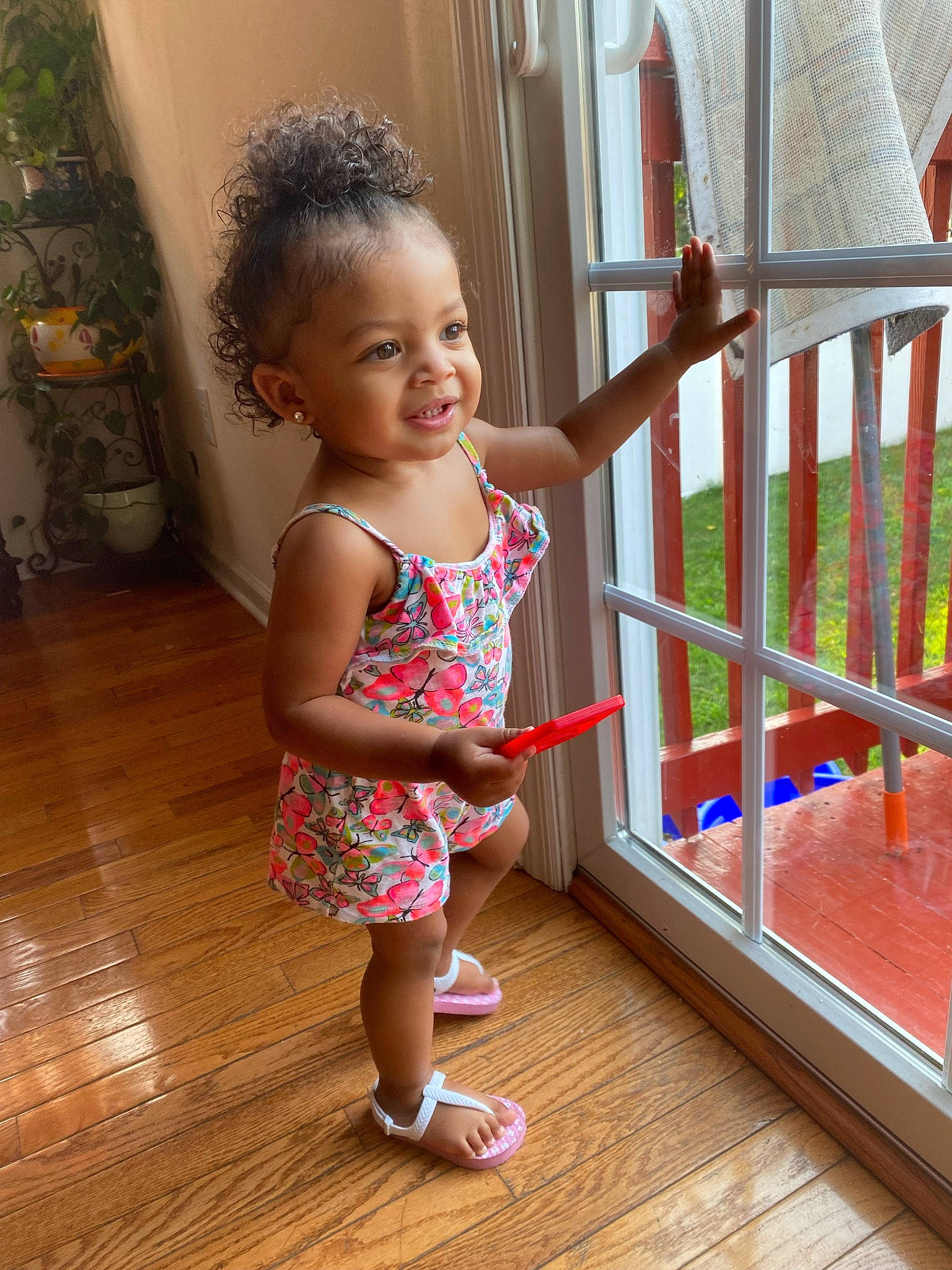 Jaelani is registered to the contest to win money with this photo: baby_toddler_clothing, child, floor, flooring, fun, happy, hardwood, human_leg, leg, leisure, pattern, person, pink, porch, product, sandal, skin, smile, standing, toddler