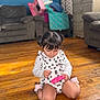 casual, child, clothing, cushions, cute, floor, focused, furniture, home, indoor, living_room, person, pigtails, pink, portrait, sitting, sofa, toddler, toy, wooden_floor
