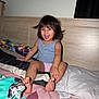 Juliette is registered to the contest to win money with this photo: bed, blanket, casual, child, clothing, curtain, face, foot, furniture, hair, hand, happy, indoor, person, pillow, room, skin, smile, toddler, wood