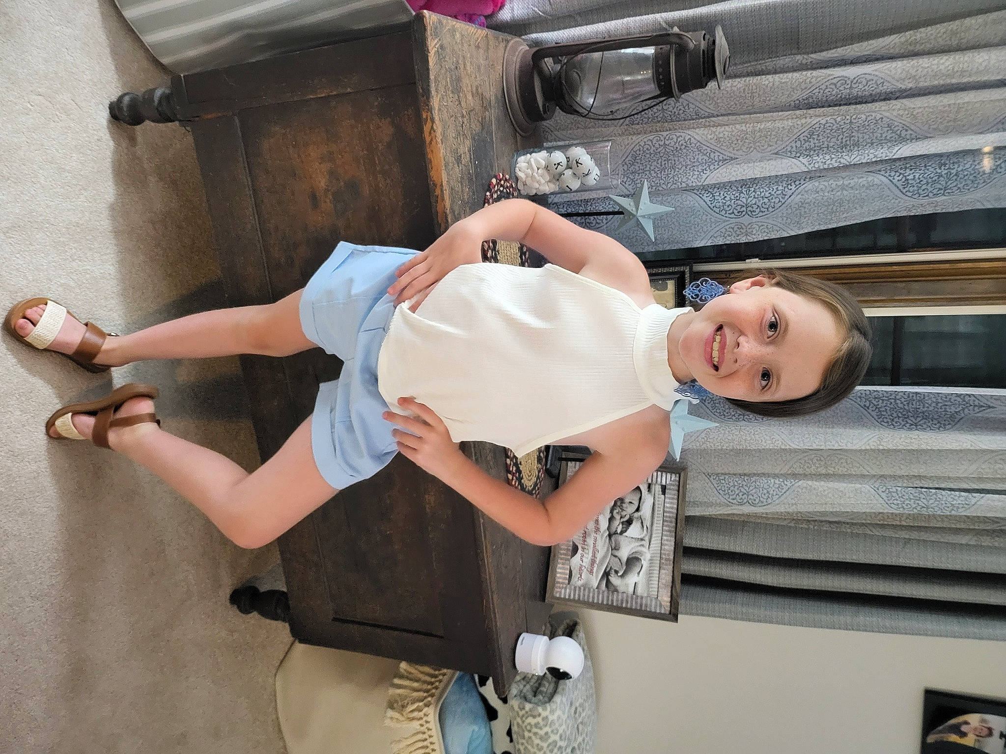 Korie is registered to the contest to win money with this photo: auto_part, automotive_exterior, bumper, comfort, elbow, foot, fun, hat, human_leg, joy, knee, motor_vehicle, person, room, sandal, shorts, smile, thigh, toddler, vacation