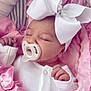 Millie Mae is registered to the contest to win money with this photo: baby, infant, sleeping, pacifier, white_bow, headband, pink_blanket, soft_texture, clothing, newborn, cute, hand, face, portrait, cozy, resting, child, blanket, sleeper, adorable