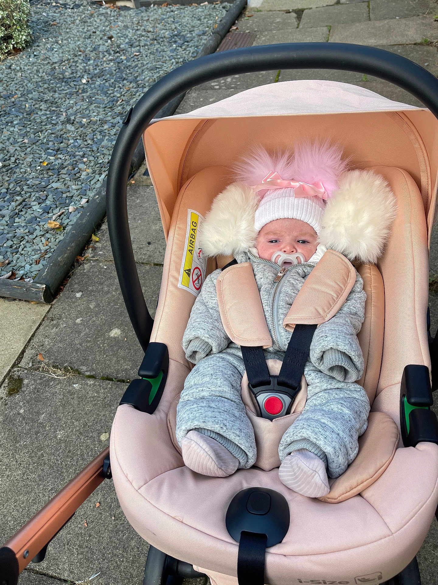 Millie Mae joined the competition — help win amazing prizes! baby, stroller, pacifier, hat, pom_poms, coat, baby_clothes, outdoor, sidewalk, gravel, pavement, infant, child, seat_belt, car_seat, pink, gray, winter_clothing, warm, bundle