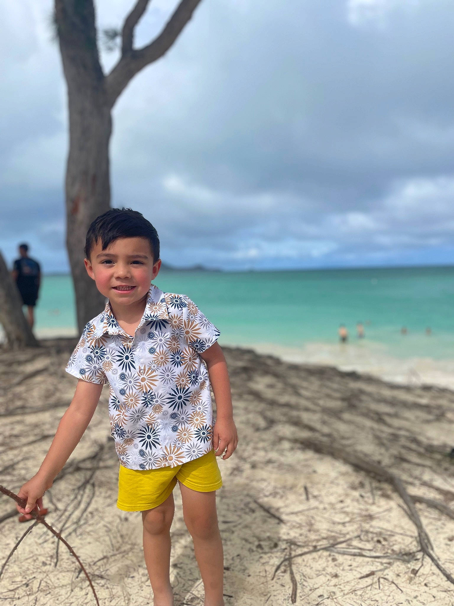 Miguel is registered to the contest to win money with this photo: beach, cloud, coast, fun, happy, holiday, horizon, joy, landscape, leisure, people_in_nature, person, rock, sand, shorts, sky, smile, toddler, travel, tree