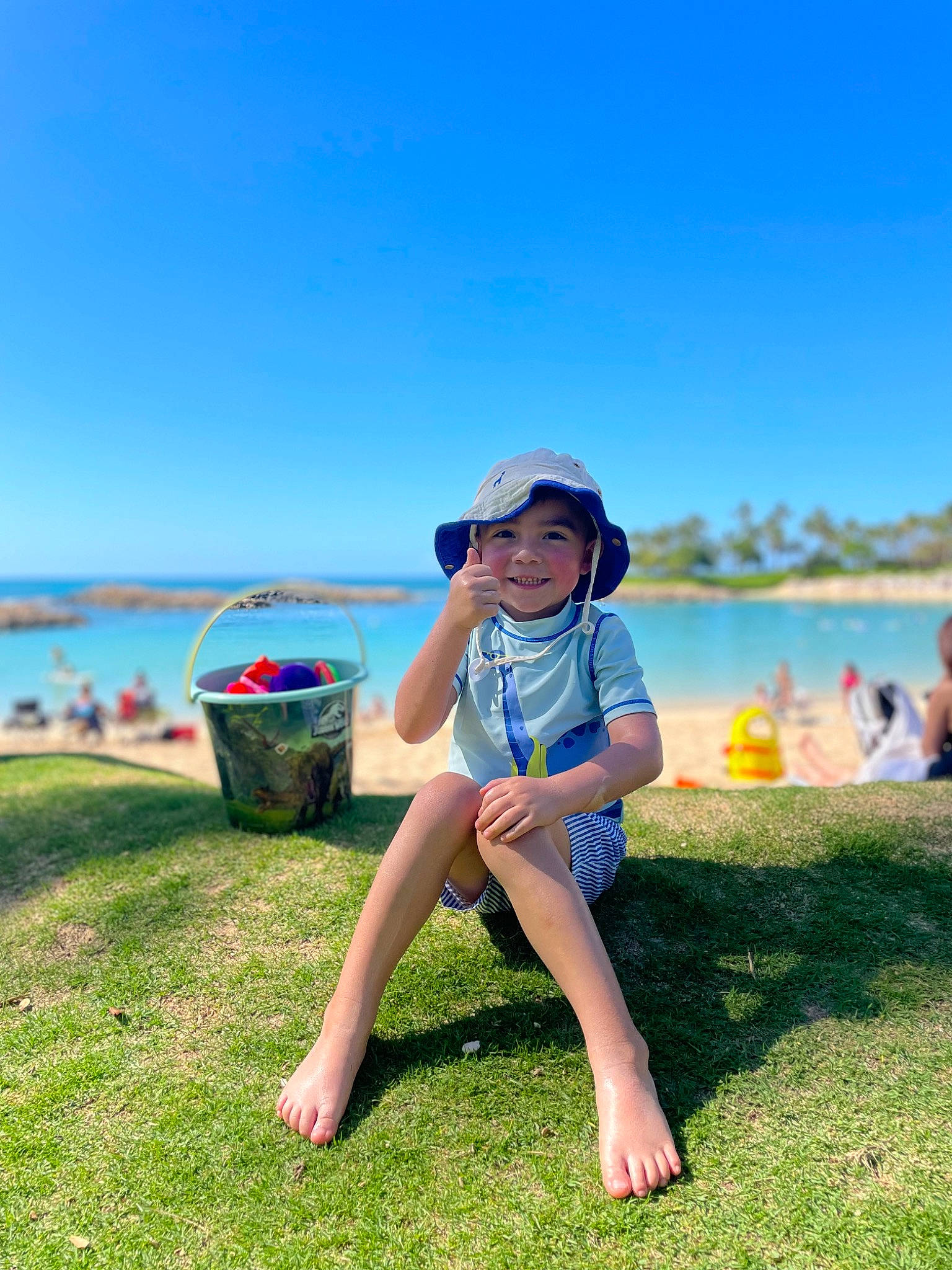 Miguel joined the competition — help win amazing prizes! fun, grass, grassland, happy, hat, headwear, joy, lake, landscape, leisure, outdoor_recreation, people_in_nature, person, plant, recreation, sky, smile, sun_hat, sunlight, toddler
