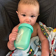 Lamichael joined the competition — help win amazing prizes! baby, blanket, chair, child, clothing, comfort, cup, curious, drink, expression, eyes, face, hand, head, indoor, portrait, seat, sippy_cup, skin, young