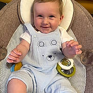Marley joined the competition — help win amazing prizes! baby, smiling, child, infant, overalls, baby_seat, toy, happy, cute, face, hands, blue_clothing, indoor, cushion, mesh, seat_belt, skin, blond_hair, portrait, young_child
