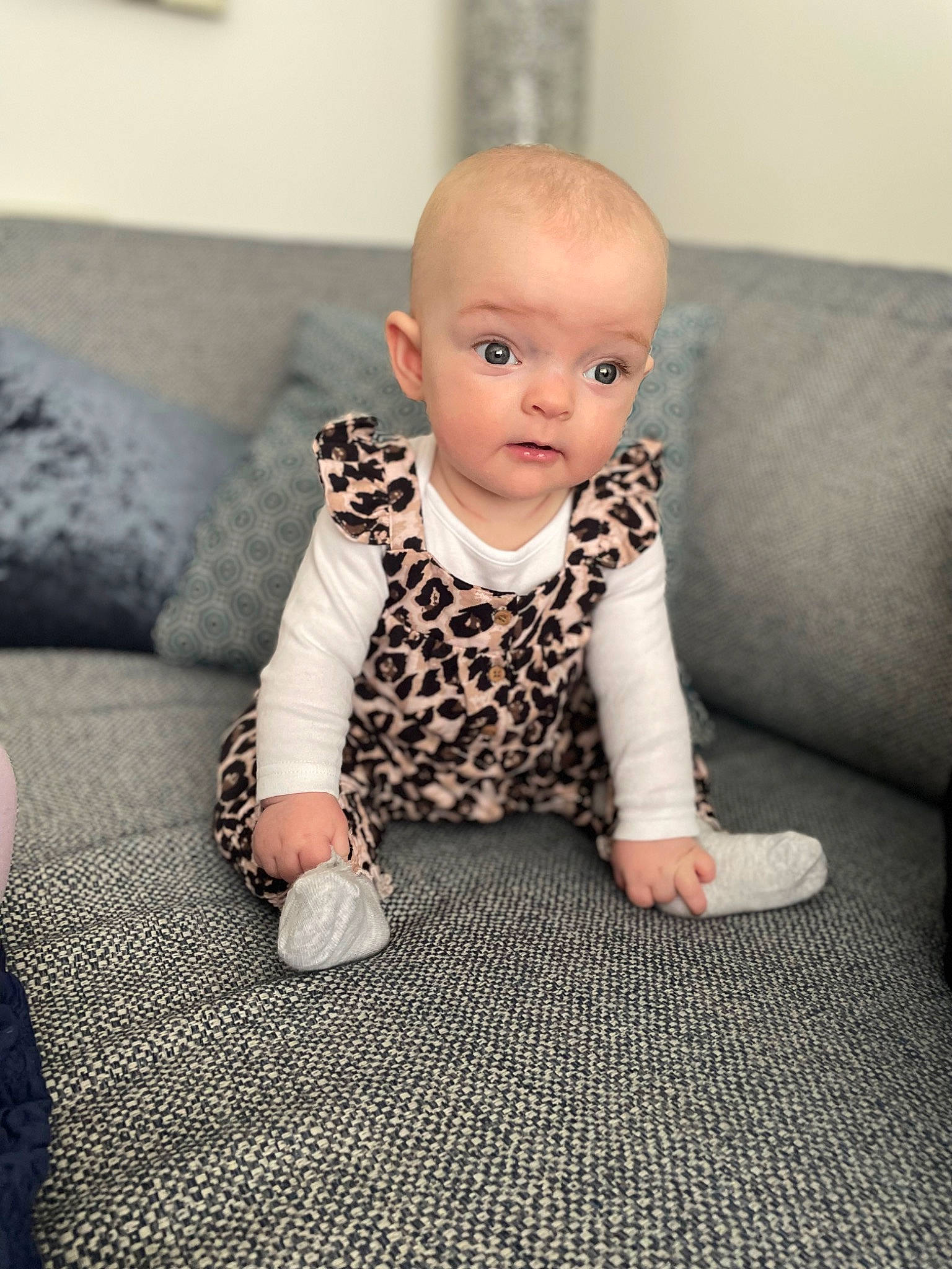 Willow Rae joined the competition — help win amazing prizes! baby, baby_toddler_clothing, carpet, cheek, child, comfort, couch, flash_photography, floor, flooring, grey, hardwood, iris, pattern, person, room, sitting, skin, sleeve, toddler