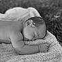 baby, sleeping, towel, outdoor, flower, black_and_white, peaceful, infant, skin, face, arm, hand, head, nature, grass, soft_texture, closeup, portrait, rest, serene