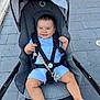 Pol a rejoint le concours — aidez-le/la à gagner de superbes lots ! baby, stroller, child, smile, blue_clothing, pacifier, outdoor, pavement, seatbelt, harness, barefoot, cute, infant, sunlight, happy, baby_toy, legs, head, person, transport