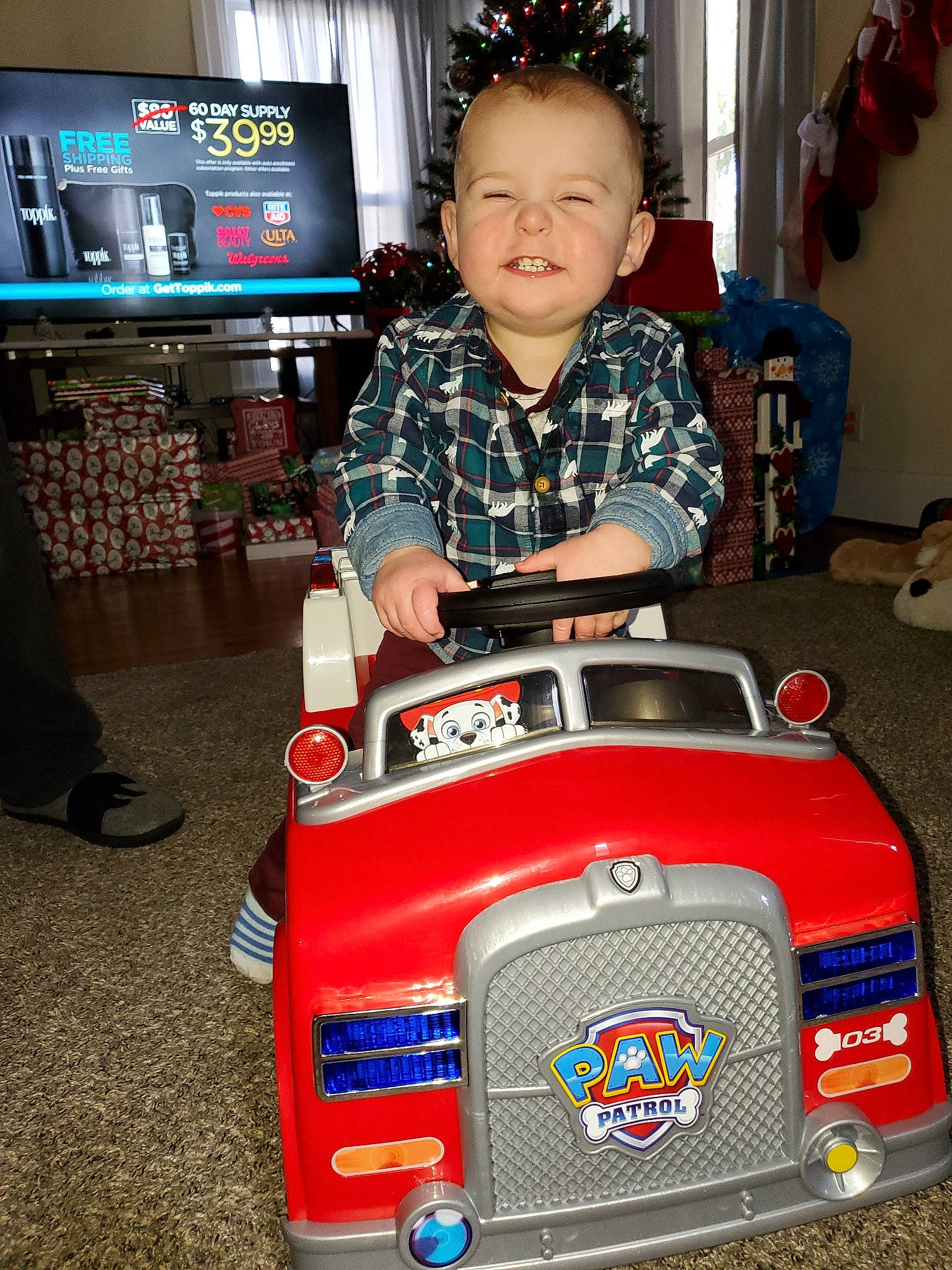 Eliott is registered to the contest to win money with this photo: automotive_exterior, car, child, joy, machine, person, toddler, toy, toy_vehicle, vehicle