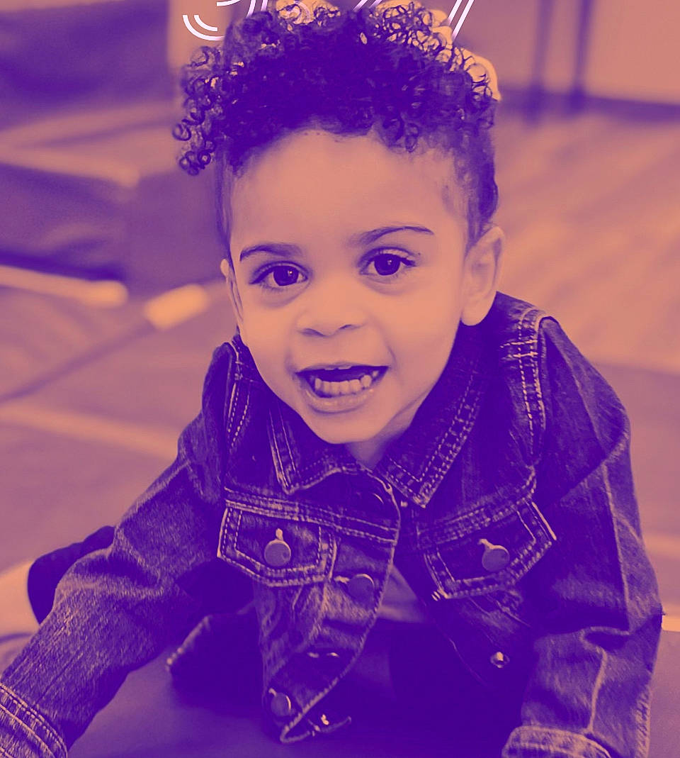 Laila is registered to the contest to win money with this photo: baby_toddler_clothing, child, cool, electric_blue, fashion_accessory, flash_photography, fun, grass, happy, headband, headpiece, human, laugh, magenta, nose, person, purple, sitting, sleeve, smile