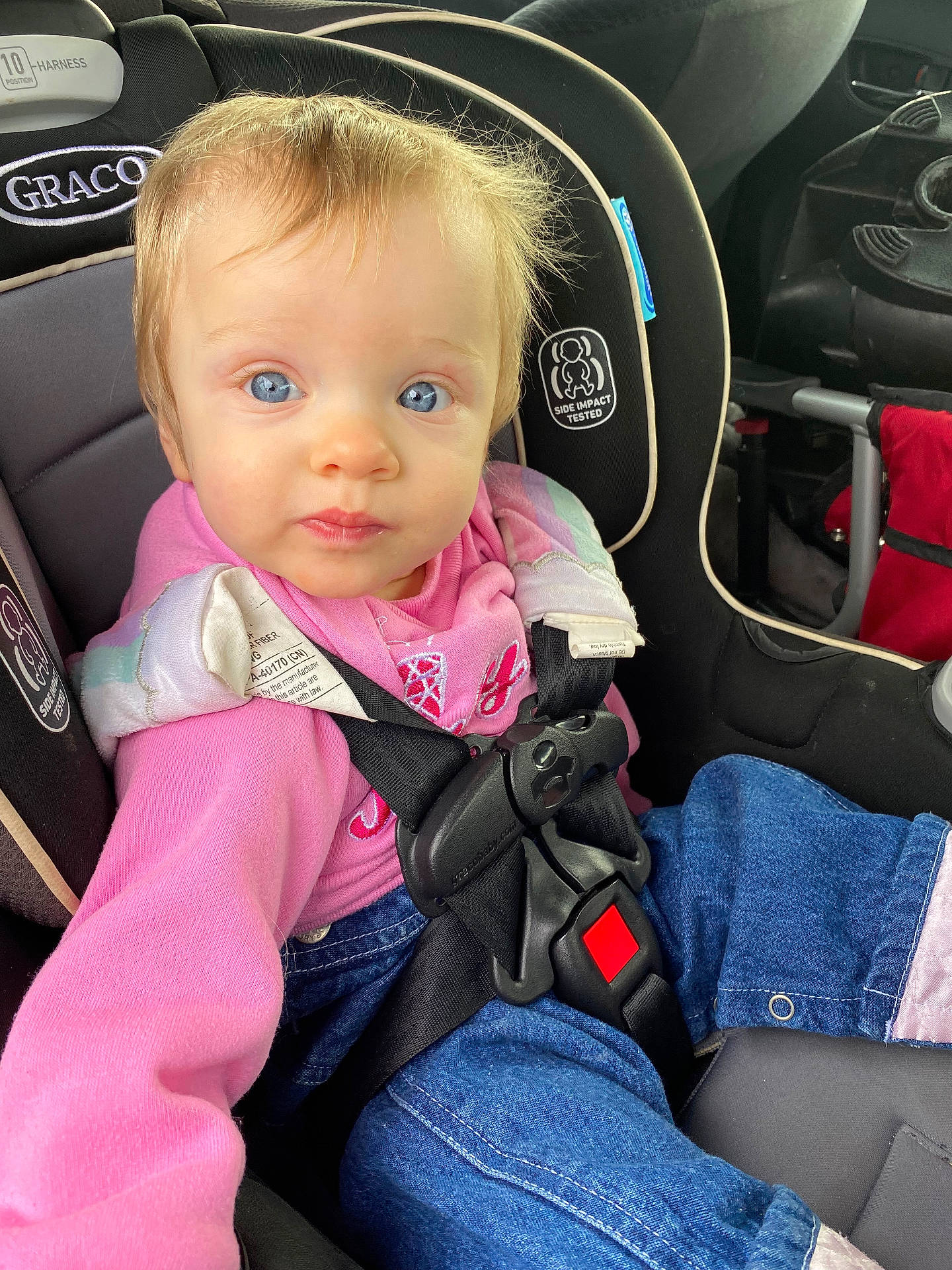 accessories, baby, belt, car, car_interior, clothing, coat, cushion, face, head, homedecor, jacket, jeans, pants, person, photography, portrait, sitting, transportation, vehicle