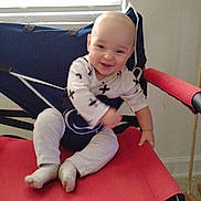 Kasson joined the competition — help win amazing prizes! baby, baby_girl, barefoot, chair, child, clothing, cute, face, floor, gray_pants, happy, head, indoor, light, person, red_chair, sitting, smiling, white_shirt, window