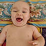 Kasson is registered to the contest to win money with this photo: baby, bare_chest, child, chubby, closeup, colorful, cute, expression, face, hand, happy, indoors, infant, joyful, lying_down, patterned_blanket, portrait, skin, smiling, young