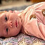 baby, infant, newborn, face, eyes, pajamas, pink_clothing, blanket, textured_blanket, close_up, lying_down, portrait, soft_texture, bear_print, cheek, skin, gaze, sleepy, pacifier, adorable