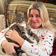 Daisy May joined the competition — help win amazing prizes! blanket, cat, comfort, couch, cozy, curtains, face, friendly, furniture, hair, hand, home, indoor, pet, portrait, relaxing, smile, sweater, tabby_cat, woman