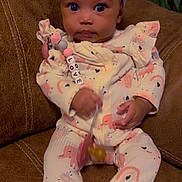 Love is registered to the contest to win money with this photo: baby, bow, child, clothing, couch, cute, hand, headband, heart, indoors, infant, leather, love, onesie, pacifier, person, portrait, rainbow, seated, toy