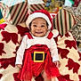 Love is registered to the contest to win money with this photo: baby, smiling, christmas, holiday, santa_hat, red_dress, gift_boxes, blanket, festive, cute, infant, indoors, happy, person, holiday_decor, christmas_theme, red_and_white, toddler, celebration, portrait