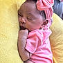 baby, newborn, sleeping, pink_clothing, headband, bow, cushion, yellow, soft_texture, infant, peaceful, closeup, child, adorable, resting, indoor, portrait, cute, toddler, skin