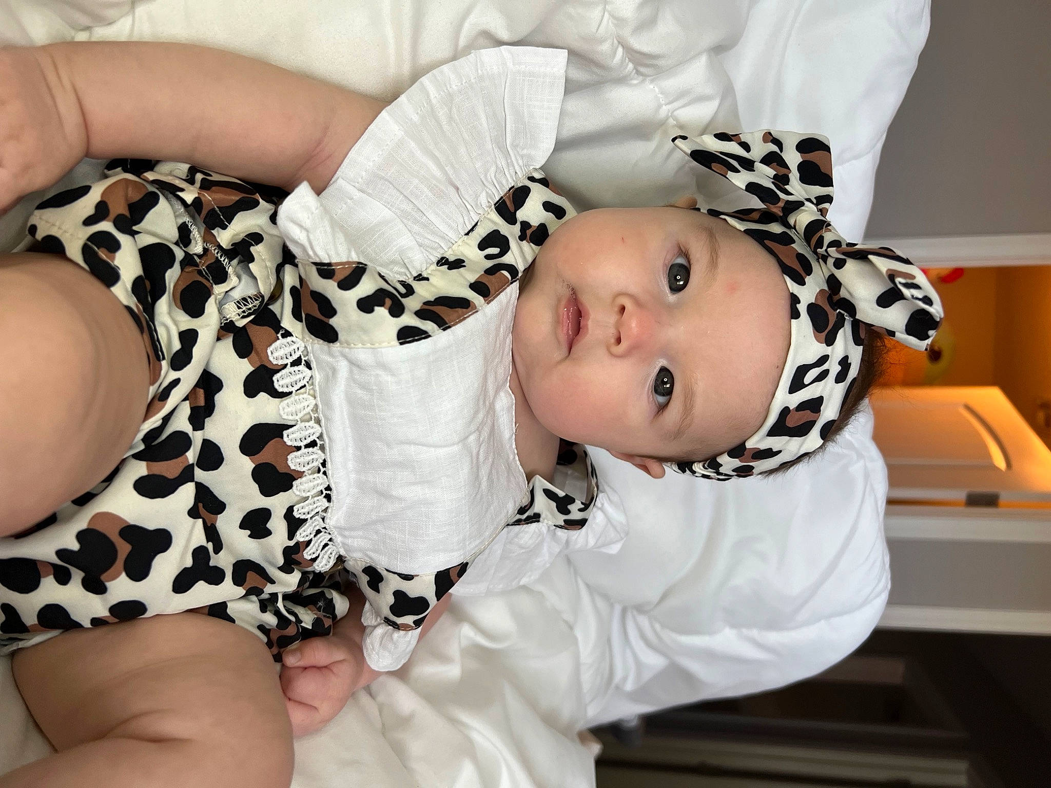 Liliana joined the competition — help win amazing prizes! arm, baby, baby_toddler_clothing, cheek, child, comfort, facial_expression, fur, happy, headgear, headwear, human, human_leg, pattern, person, sitting, skin, sleeve, smile, thigh