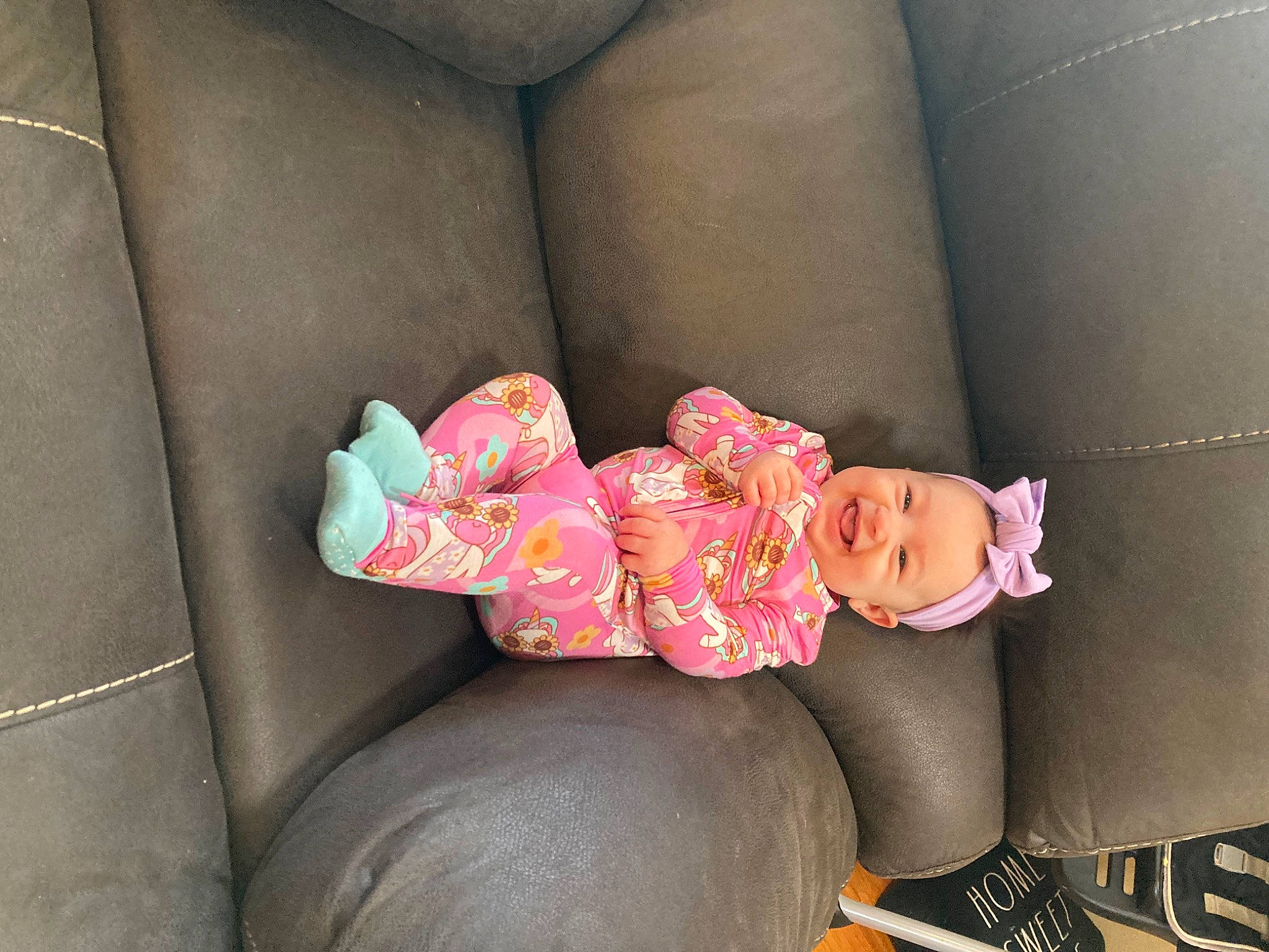 Emma is registered to the contest to win money with this photo: auto_part, baby, baby_products, baby_toddler_clothing, car_seat, comfort, couch, dress, fashion_accessory, foot, human_body, human_leg, joy, lap, nail, person, pink, sleeve, sock, thigh