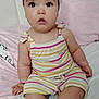 Daphne Nicolle is registered to the contest to win money with this photo: baby, child, infant, headband, flower, striped_clothing, romper, sitting, bed, blanket, pink, white, socks, cute, indoors, portrait, face, eyes, expression, soft