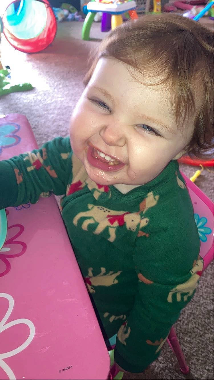 Oaklynn is registered to the contest to win money with this photo: baby, baby_toddler_clothing, cheek, child, face, facial_expression, fun, grass, happy, head, human_body, nose, person, pink, play, sitting, skin, sleeve, smile, t_shirt